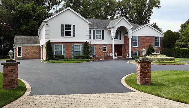 large house with asphalt driveway